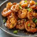 Close-up of air fryer shrimp teriyaki with a glossy sauce and sesame seeds