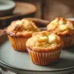 Close-up of freshly baked apple muffins on a white plate, perfect for kids.