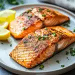 Close-up of baked salmon in an air fryer with a clean background