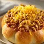 Close-up of cheesy garlic bread sloppy joes with melted cheese and garlic on a clean background.