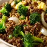 Close-up of ground beef and broccoli fried quinoa with vibrant colors and textures