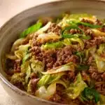 Close-up of a ground beef and cabbage stir fry with vibrant vegetables in a skillet