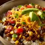 Close-up of ground beef taco rice bowls with fresh toppings