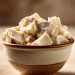 Close-up of a hearty slow cooker beef tallow dish with rich textures and warm lighting.