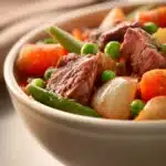 Close-up of a hearty beef dish in a slow cooker with rich textures and warm lighting.