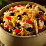 Close-up of a high protein chicken enchilada bowl with vibrant toppings and creamy sauce