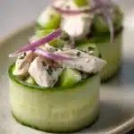 Close-up of high protein chicken salad cucumber roll with creamy sauce and fresh herbs