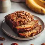 Close-up of hummingbird banana bread with a light, warm background.