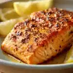 Close-up of lemon air fryer salmon with bright, natural lighting and a clean background.