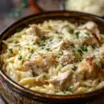 Close-up of one pot chicken orzo with creamy sauce and herbs