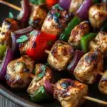 Close-up of skillet chicken kabobs with bright, natural lighting and minimal background