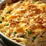 Close-up of a creamy tuna noodle casserole in a pan with noodles and sauce