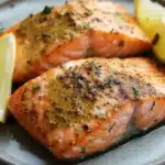 Close-up of air fryer salmon with dijon mustard glaze on a white plate.