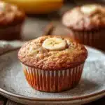 Close-up of banana muffins with Greek yogurt on a white plate, showcasing their moist texture.