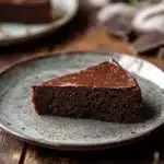 Close-up of a low sugar chocolate cake with rich texture and minimal background.
