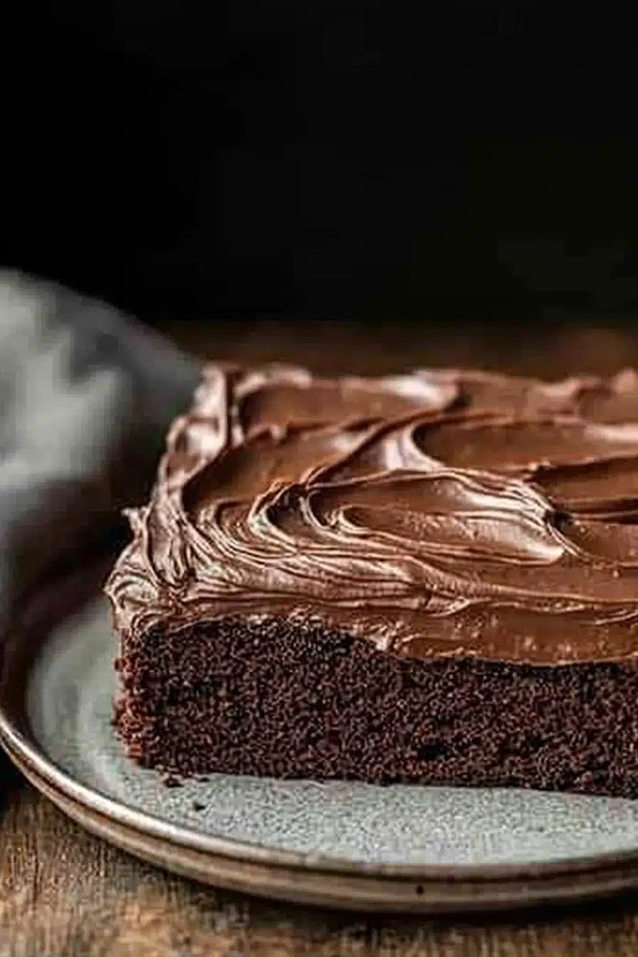 Close-up of a delicious sheet cake with a smooth frosting and decorative toppings.