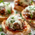 Close-up of garlic bread meatballs with a golden crust and herbs