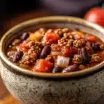 Close-up of a hearty slow cooker chili by Sarah DiGregorio with beans and spices.