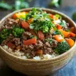 Close-up of a high protein beef and rice bowl with vibrant colors and fresh ingredients.