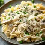 Close-up of a low calorie chicken noodle casserole with creamy sauce and herbs.
