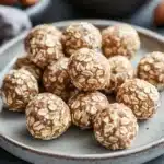 Close-up of oatmeal cookie energy bites on a clean background with warm lighting.