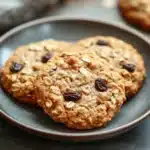 Close-up of oatmeal cookies on a clean white background, showcasing texture and detail.