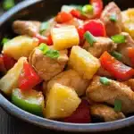 Close-up of slow cooker chicken Hawaiian with creamy sauce and herbs