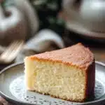 Close-up of a vanilla cake with a smooth, creamy texture and a clean background.