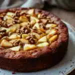 Close-up of apple cake with applesauce, showcasing a moist texture and golden crust.