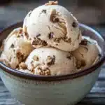 Close-up of peanut butter cookie ice cream with a creamy texture and cookie pieces.